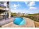 Resort style pool with brick surround and tropical landscaping in the backyard at 6805 Arroyo Dr, New Port Richey, FL 34652