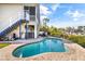 Gorgeous swimming pool with brick surround, and beautiful tropical landscaping at 6805 Arroyo Dr, New Port Richey, FL 34652