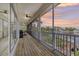 Relaxing screened porch with outdoor furniture and panoramic lake views at sunset at 6805 Arroyo Dr, New Port Richey, FL 34652