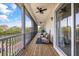 Spacious screened porch with outdoor seating and ceiling fans provides gorgeous views of the lake at 6805 Arroyo Dr, New Port Richey, FL 34652