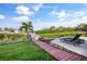 Beautiful waterfront view featuring a wooden boardwalk, waterfront and lovely lawn at 6805 Arroyo Dr, New Port Richey, FL 34652