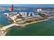 Aerial view of waterfront condos with pool, tennis courts, and boat docks at 7910 Sun Island S Dr # 404, South Pasadena, FL 33707