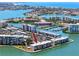 Aerial view of waterfront condos with boat docks and canals surrounded by lush landscaping at 7910 Sun Island S Dr # 404, South Pasadena, FL 33707