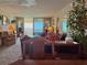 Spacious living room with a waterfront view, access to a balcony, and comfortable seating at 7910 Sun Island S Dr # 404, South Pasadena, FL 33707