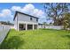 Expansive backyard view showcasing a well-maintained lawn and covered patio at 816 W Orient St, Tampa, FL 33603