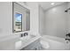 Modern bathroom with sleek vanity, framed mirror, and a tub/shower combo at 816 W Orient St, Tampa, FL 33603