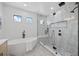 This bathroom features a soaking tub and a glass-enclosed shower with neutral-toned tile and black fixtures at 816 W Orient St, Tampa, FL 33603