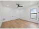 Minimalist bedroom with hardwood floors, closet, ceiling fan and a bright window at 816 W Orient St, Tampa, FL 33603
