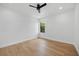 This is a clean, bright bedroom with a ceiling fan, hardwood floors, and a window offering natural light at 816 W Orient St, Tampa, FL 33603