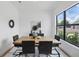 Modern dining room with wood table, black chairs, and a large window overlooking the yard at 816 W Orient St, Tampa, FL 33603