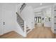 Inviting entryway showcases an open floor plan with wood floors and a staircase with black metal railings at 816 W Orient St, Tampa, FL 33603