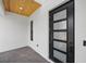 Close-up of a modern front door with glass panels and brick flooring at 816 W Orient St, Tampa, FL 33603