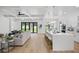 Open-concept living room with a kitchen island and hardwood floors at 816 W Orient St, Tampa, FL 33603