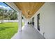 Inviting covered patio with a wood ceiling, ceiling fans, and backyard views at 816 W Orient St, Tampa, FL 33603