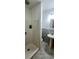 Modern bathroom with a walk-in shower and pedestal sink at 8207 Volusia Pl, Tampa, FL 33637