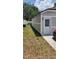 Side view of the home's exterior, showing the siding and entrance door at 8207 Volusia Pl, Tampa, FL 33637
