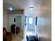 Hallway with tile flooring, closet with mirrored door, and desk at 8207 Volusia Pl, Tampa, FL 33637