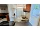Laundry room featuring a sink, counter, and ironing board at 8207 Volusia Pl, Tampa, FL 33637