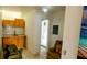 Bright living space with kitchenette, chair with lobster pillow, and coastal artwork at 8207 Volusia Pl, Tampa, FL 33637