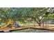 Community playground featuring slides, climbing dome, and mature shade trees at 8207 Volusia Pl, Tampa, FL 33637