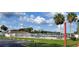 Community pool with lounge chairs, umbrellas, and palm trees on a sunny day at 8207 Volusia Pl, Tampa, FL 33637