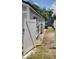 Side yard with brick pathway leading to the back, enclosed by a white privacy fence at 8207 Volusia Pl, Tampa, FL 33637