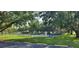 Community tennis courts surrounded by lush greenery and mature shade trees at 8207 Volusia Pl, Tampa, FL 33637