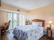 Bright bedroom with wood floors, a queen bed, balcony access, and comfortable decor at 830 S Gulfview Blvd # 102, Clearwater Beach, FL 33767