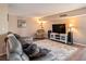Cozy living room with comfortable seating, a large TV, and a decorative rug at 830 S Gulfview Blvd # 102, Clearwater Beach, FL 33767