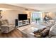Bright living room with plush seating, hardwood floors, and access to balcony at 830 S Gulfview Blvd # 102, Clearwater Beach, FL 33767