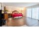 Spacious main bedroom with hardwood floors, natural light, and stylish furnishings at 830 S Gulfview Blvd # 102, Clearwater Beach, FL 33767