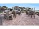 Outdoor patio featuring Adirondack chairs and a stone fire pit overlooking tropical plants at 830 S Gulfview Blvd # 102, Clearwater Beach, FL 33767