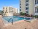 Inviting outdoor pool area with lounge chairs and lush landscaping, perfect for relaxation and enjoyment at 830 S Gulfview Blvd # 102, Clearwater Beach, FL 33767