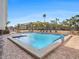Inviting community pool with lounge chairs and palm trees set under a clear blue sky at 830 S Gulfview Blvd # 102, Clearwater Beach, FL 33767