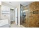 Contemporary bathroom boasts tiled shower with glass door and storage at 8417 Bay Pointe Dr, Tampa, FL 33615