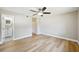 This bedroom features hardwood floors, ceiling fan, base molding, and adjacent bath at 8417 Bay Pointe Dr, Tampa, FL 33615