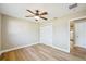 Bright bedroom with wood-look flooring and ceiling fan at 8417 Bay Pointe Dr, Tampa, FL 33615