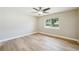 Bedroom features hardwood floors, ceiling fan, and window showcasing the neighborhood at 8417 Bay Pointe Dr, Tampa, FL 33615