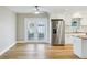 Dining room featuring bright light, stainless refrigerator, and white cabinetry at 8417 Bay Pointe Dr, Tampa, FL 33615