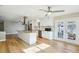 Open kitchen with stainless appliances, white cabinets, island and adjacent living area at 8417 Bay Pointe Dr, Tampa, FL 33615