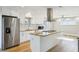 Modern kitchen features stainless steel appliances, white cabinetry, and a center island at 8417 Bay Pointe Dr, Tampa, FL 33615