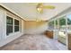 Enclosed sunroom offers tile flooring and multiple ceiling fans at 8417 Bay Pointe Dr, Tampa, FL 33615
