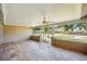 Spacious enclosed lanai with tile flooring and multiple ceiling fans at 8417 Bay Pointe Dr, Tampa, FL 33615