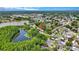Aerial view of the property with community lake access and surrounding green landscape at 9050 Lake Place Ln, Tampa, FL 33634