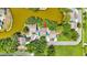 Aerial view of property backing onto a lake with mature trees at 9050 Lake Place Ln, Tampa, FL 33634