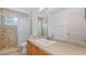 Bathroom features a tiled shower with glass door and vanity with square sink at 9050 Lake Place Ln, Tampa, FL 33634