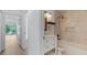 Bathroom featuring a vanity with marble countertop, tiled walls, and a bathtub with shower at 9050 Lake Place Ln, Tampa, FL 33634