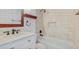 Bathroom featuring a vanity with marble countertop, tiled walls, and a bathtub with shower at 9050 Lake Place Ln, Tampa, FL 33634