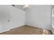 Bright bedroom with wood-look floors, white walls, and ample natural light at 9050 Lake Place Ln, Tampa, FL 33634