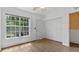 Well-lit bedroom with wood floors, a large window, and a closet at 9050 Lake Place Ln, Tampa, FL 33634